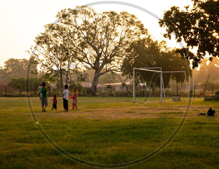A father playing games with his children at a playground, Jaipur