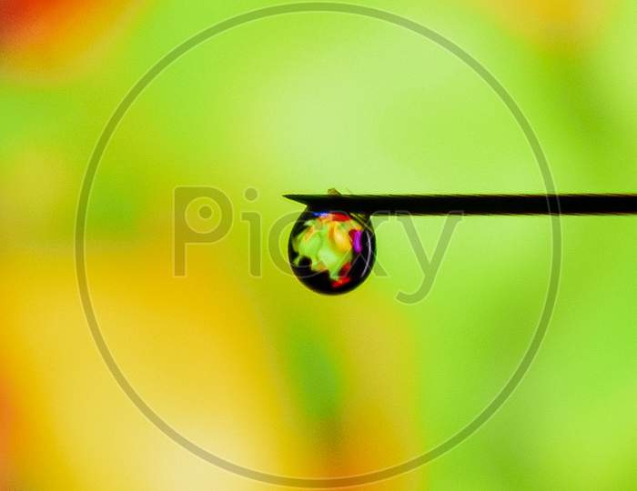 Reflection of colored wallpaper on a water drop