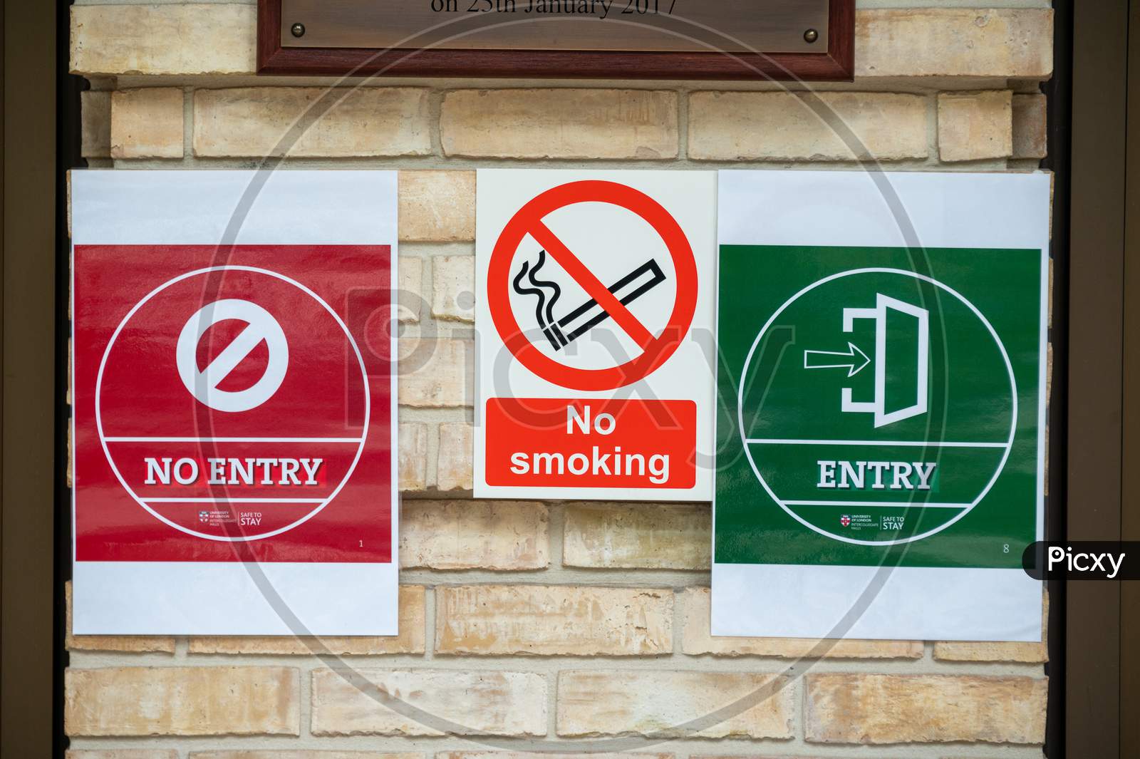 Covid 19 Social Distancing Warning Signs Alongside A No Smoking Sign On The Wall Of A Student Halls Of Residence