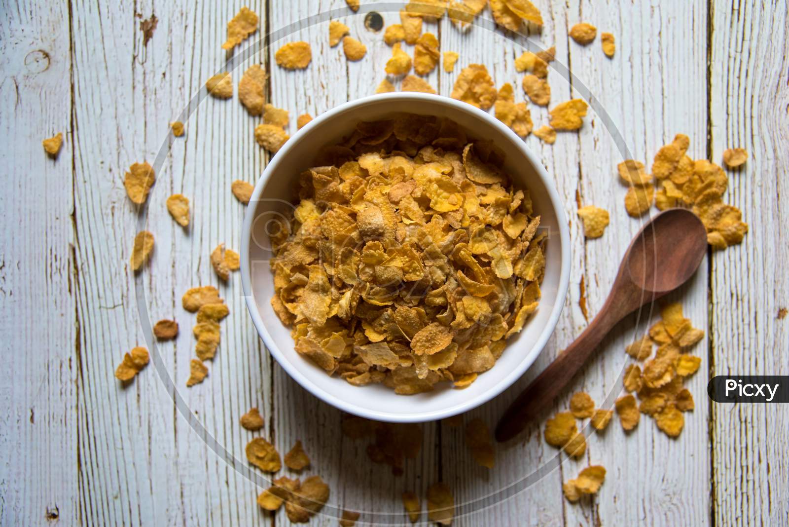 Top view of cornflakes in a bowl on a background