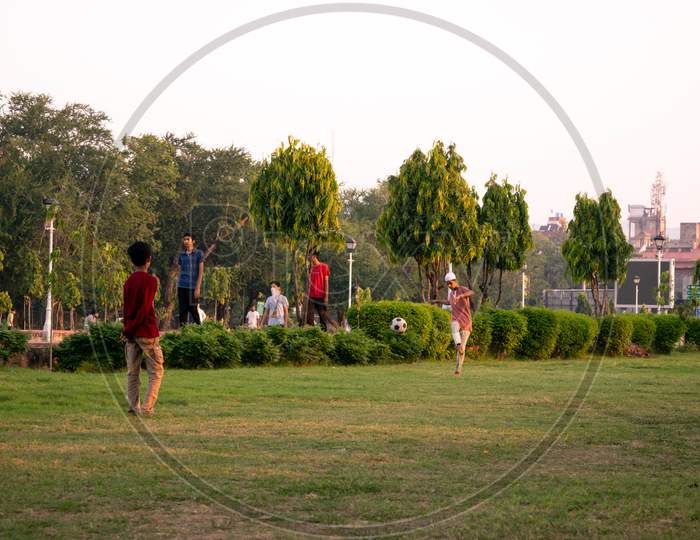 Football players playing football at a playground, Jaipur