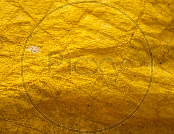 Texture Of A Creased Yellow Cloth Sheet