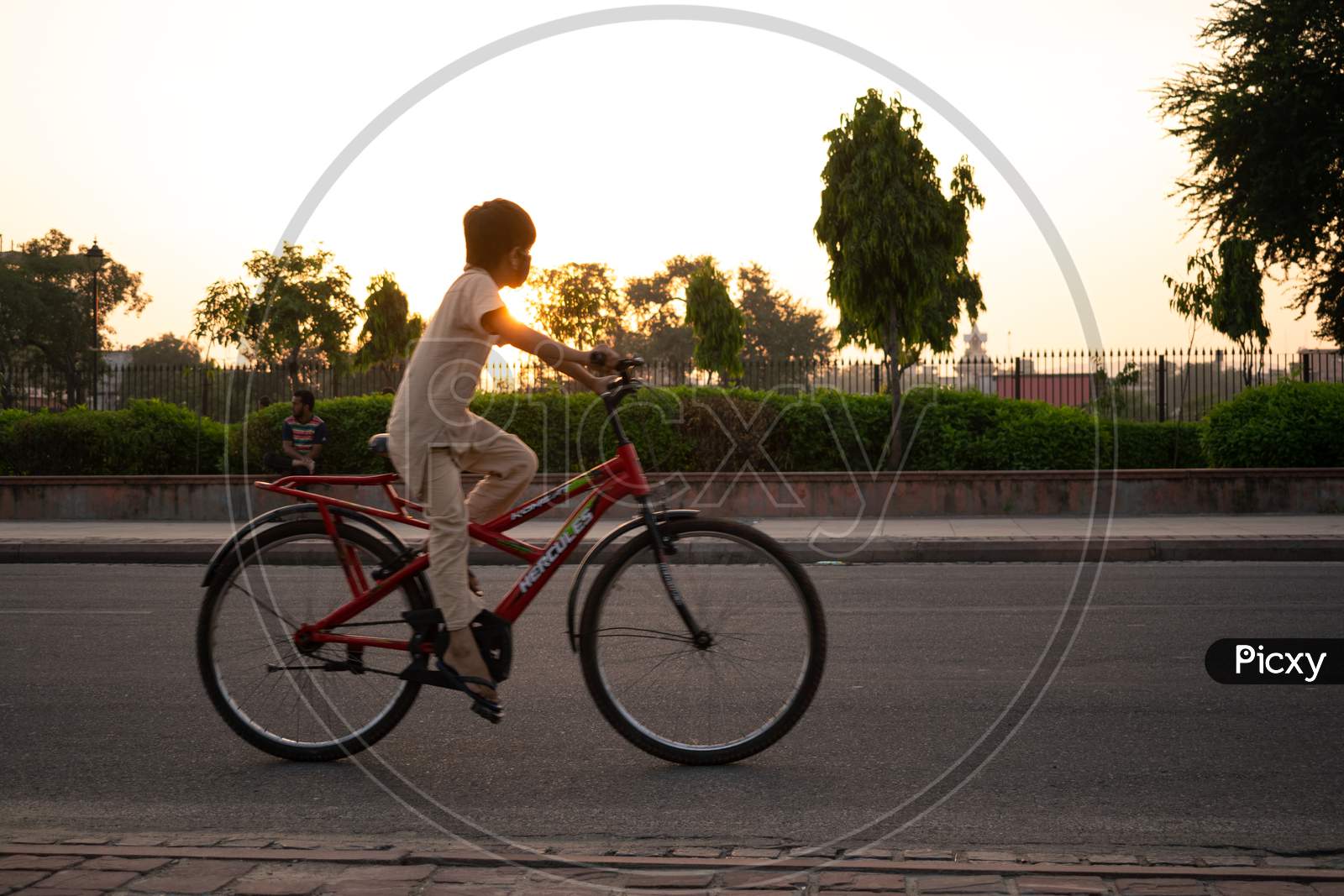 Boy, wearing mask, cycling in the morning