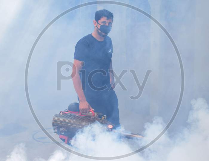 Health Worker using fogging machine