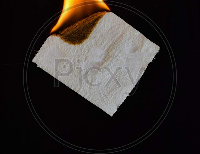 Tissue paper lit on fire flame