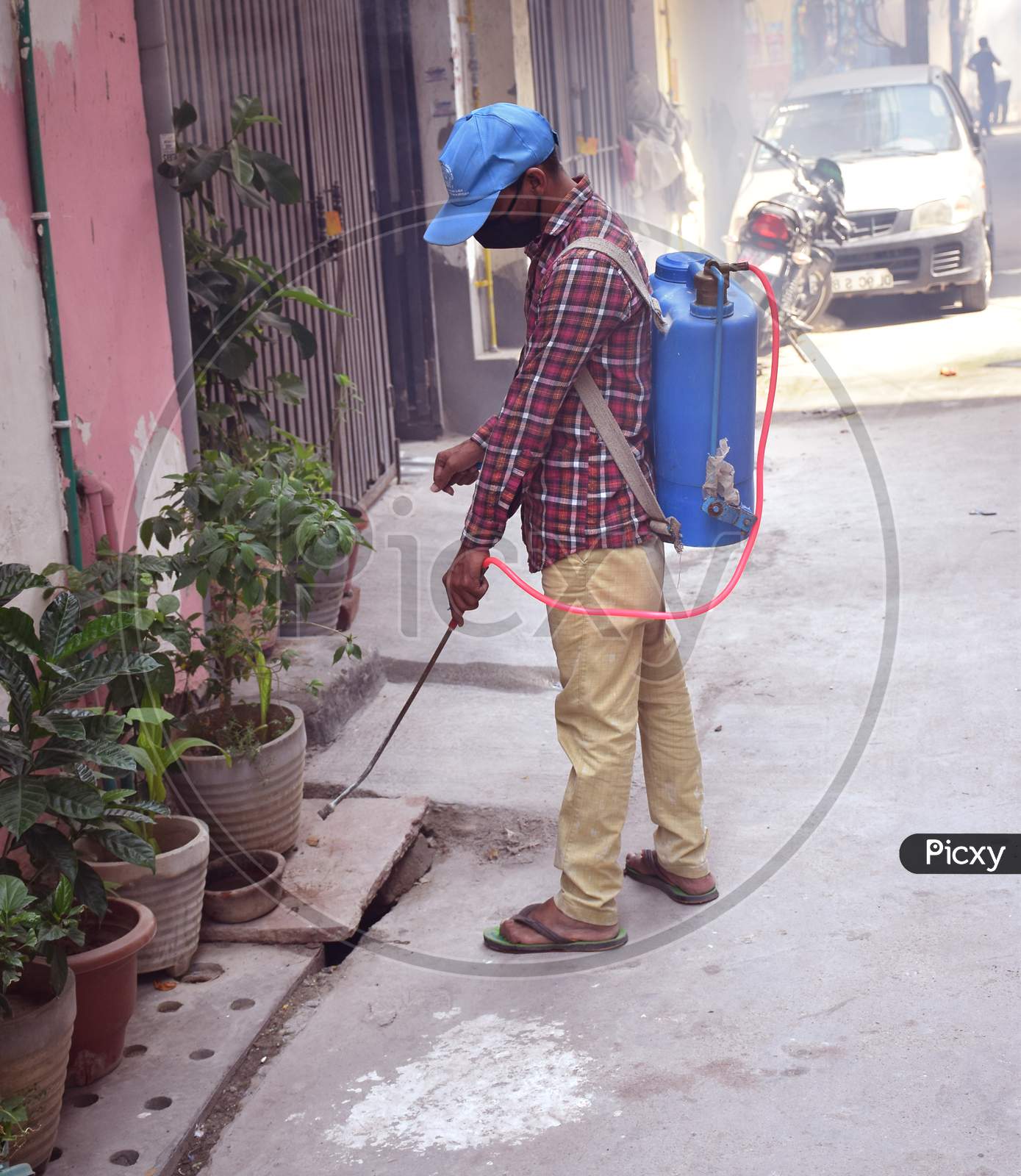 Indian Health worker spraying disinfectant