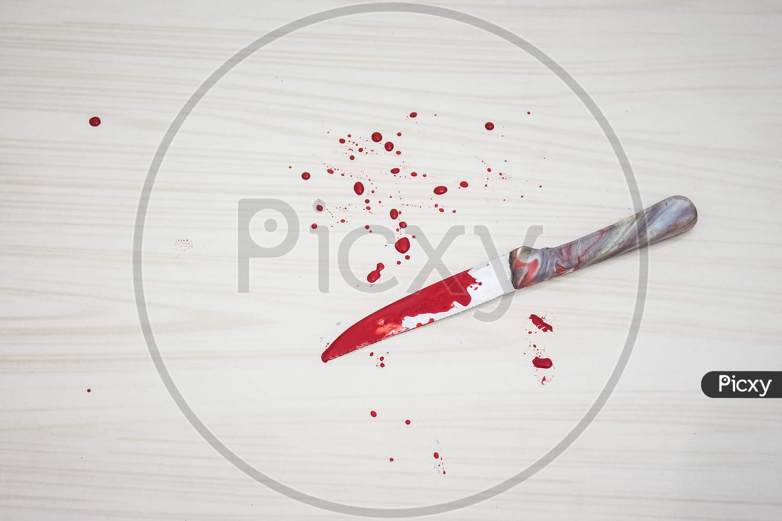 Bloody knife on the floor. knife was found at the scene of the crime. A forensic takes blood samples from the knife. Bloody knife lies on ceramic tiles background. Concept of a domestic killings.