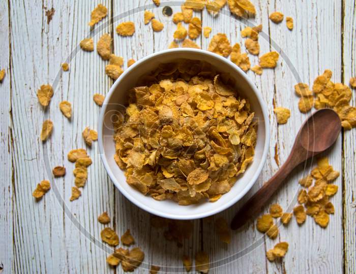 Top view of cornflakes in a bowl on a background