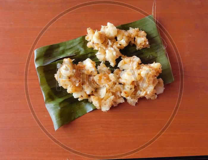 Delicious Tapioca Curry In A Banana Leaf Isolated On Wooden Surface