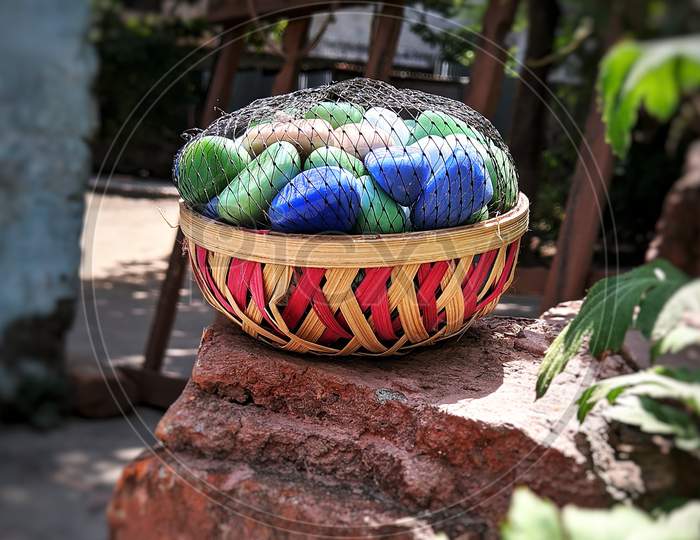 Colourful stones in the wooden basket