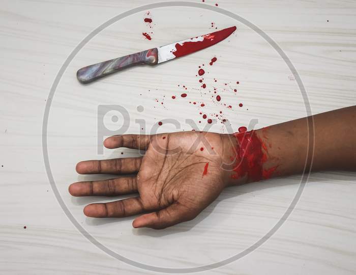 Committed Suicide Concept - Man Suicide By Knife Cutting A Wrist, Depressed Man, Sad Love, Low Self Esteem, The Knife Hand And A Lot Of Blood. To Cut My Veins On The Hand With A Kitchen Knife.