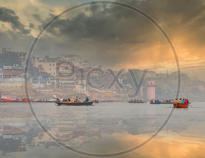 The refections of the historic homesteads of Varanasi India as seen from a boat on the river Ganges.