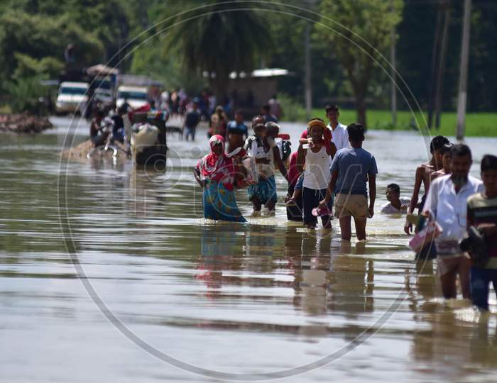 Villagers wade through a flooded road after heavy rain at  Jamunamukh  village in Hojai district of Assam on sep 29,2020.