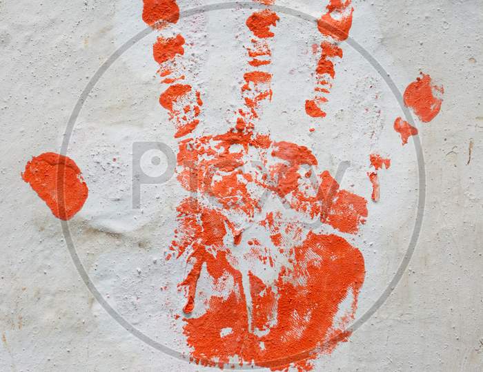 Red Hand Print On White Wall