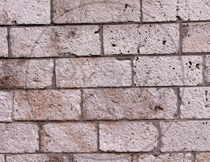 A Grey Bricked Rectangular Wall Along With Burn Marks