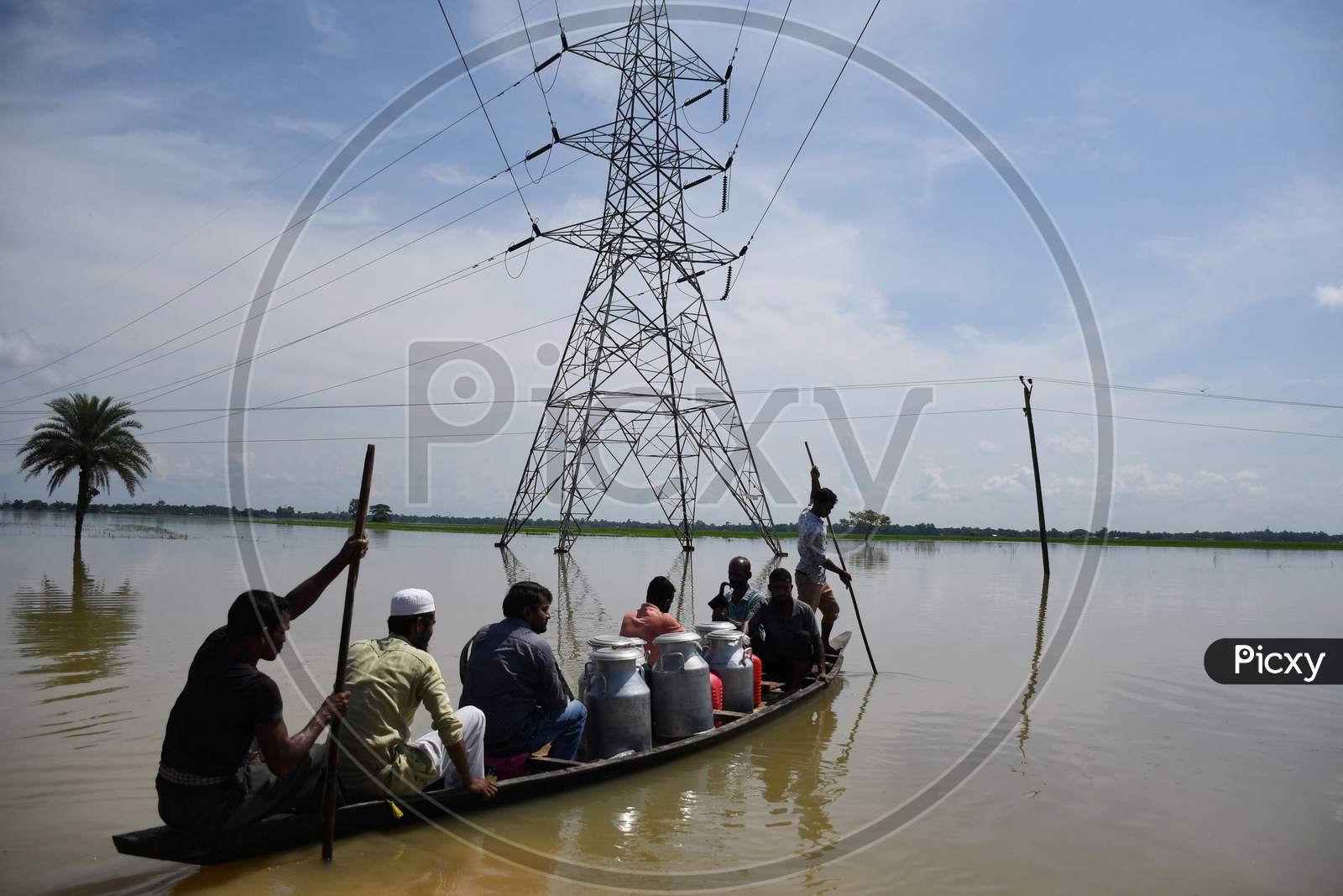 People on a boat move across the flood-affected area, at Jamunamukh  village in Hojai district of Assam on Sept 29,2020