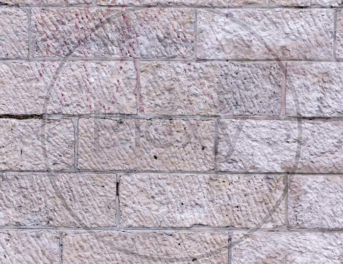 A Grey Bricked Rectangular Wall Along With Scratch Pattern