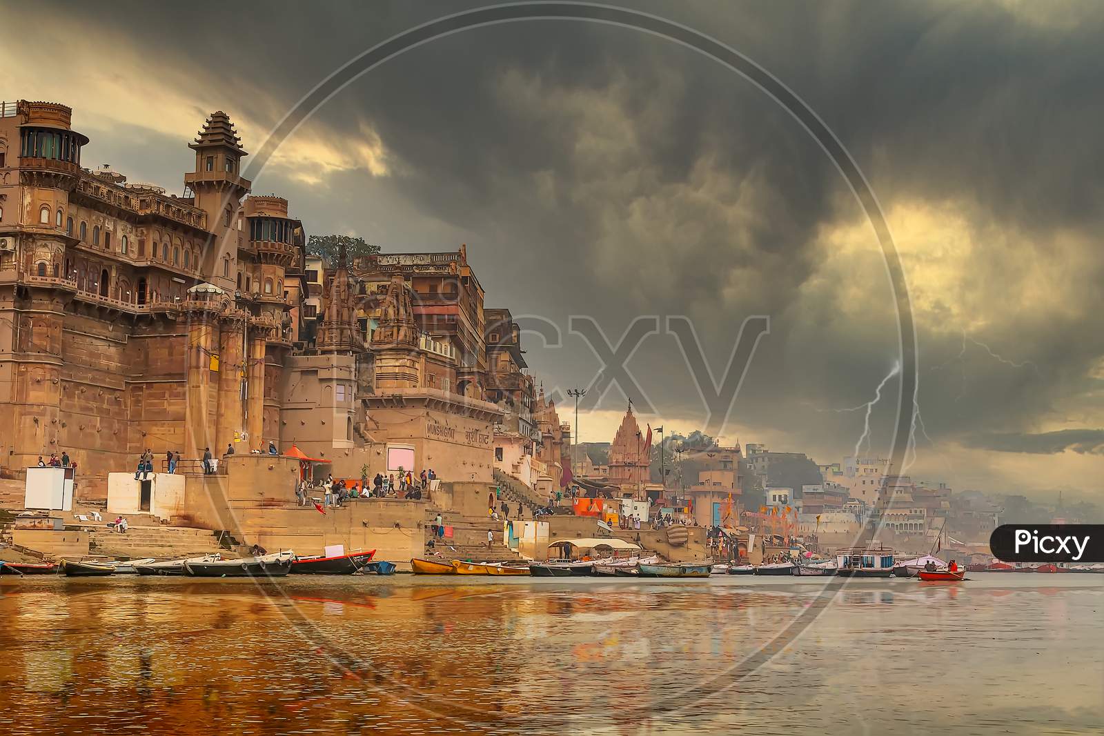 The refections of the historic buildings of Varanasi India as seen from a boat on the river Ganges