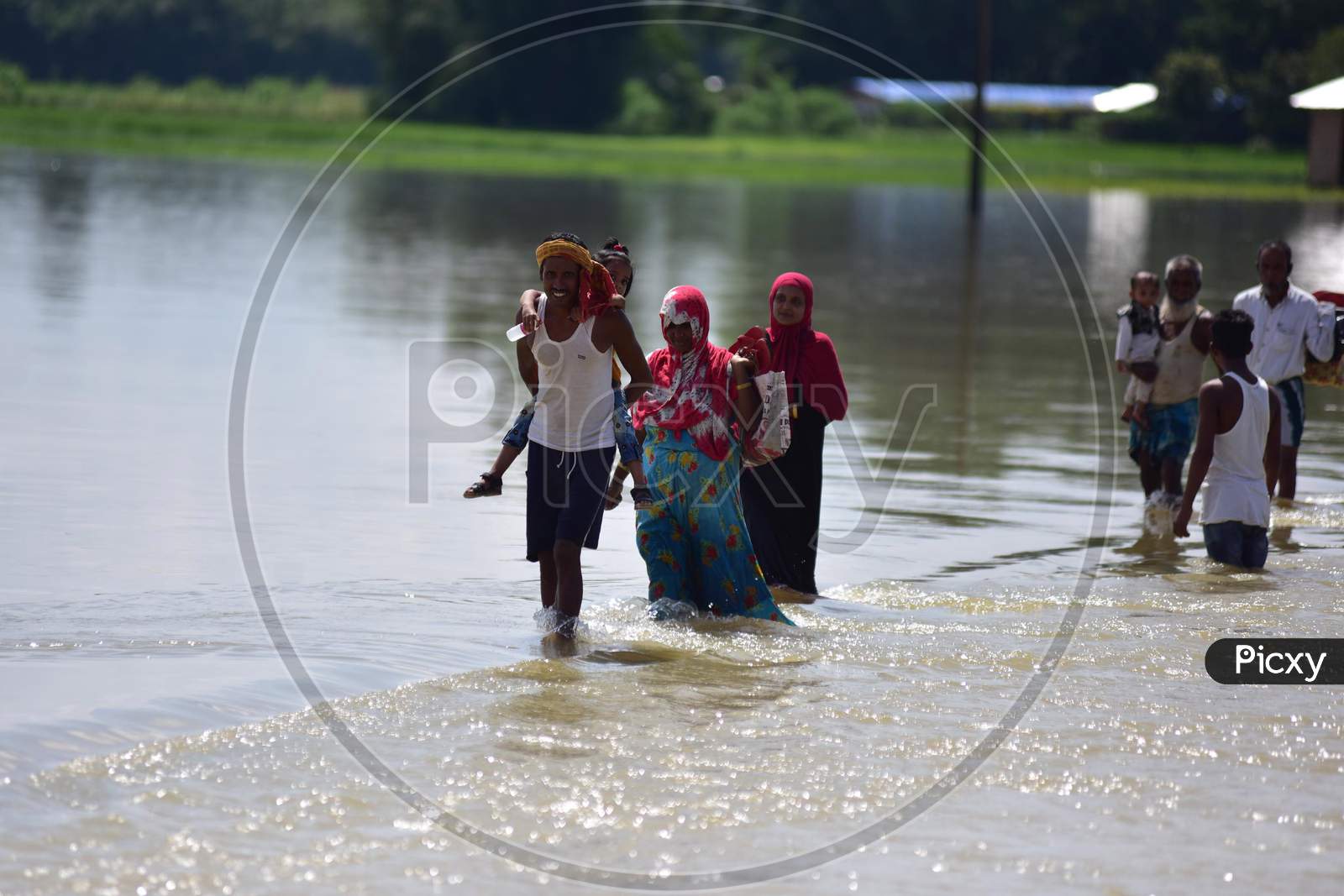 Villagers wade through a flooded road after heavy rain at  Jamunamukh  village in Hojai district of Assam on sep 29,2020.