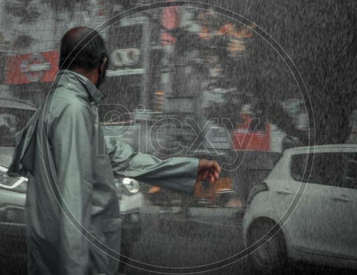 The Man Is Waiting For An Taxi In Rain