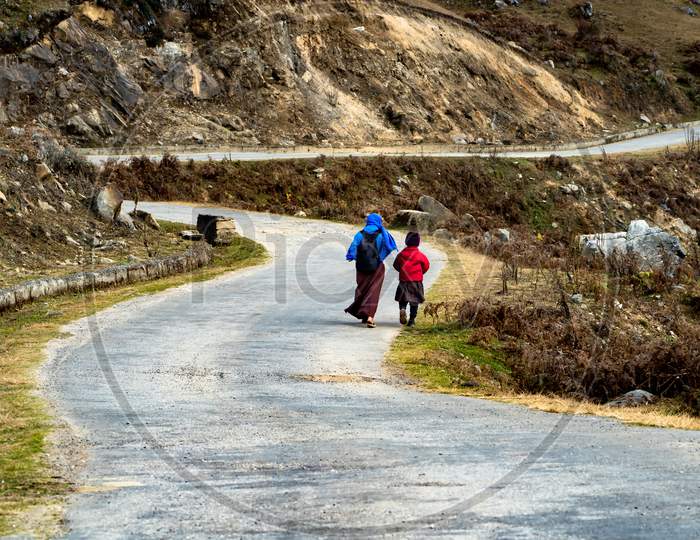 Walking Mother & Son By Road At Bhutan