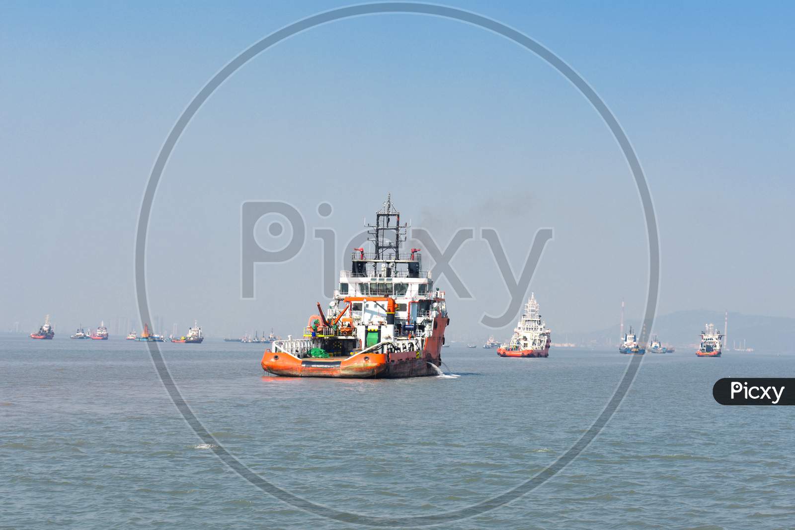 A Orange Rescue Boat Floating In The Vast Blue Water In Mumbai