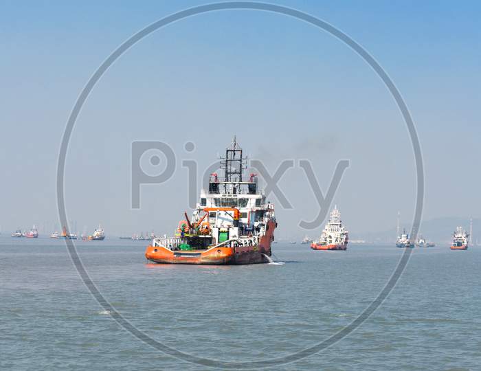 A Orange Rescue Boat Floating In The Vast Blue Water In Mumbai