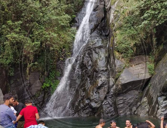 peoples enjoying in beautiful waterfall in India Himalayas mountains Dharamshala Mcleodganj triund Himachal Pradesh