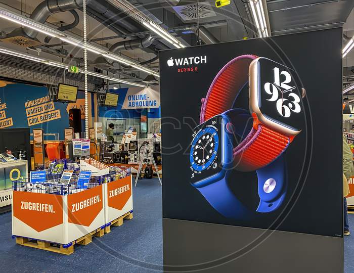 Darmstadt, Germany - September 25th 2020: A photographer visiting a Saturn market taking pictures of the Apple area with displays of the new Apple Watch Series 6 and other devices.