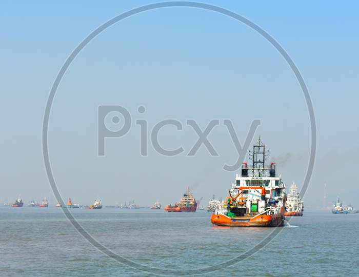 A Orange Rescue Boat Floating In The Vast Blue Water In India