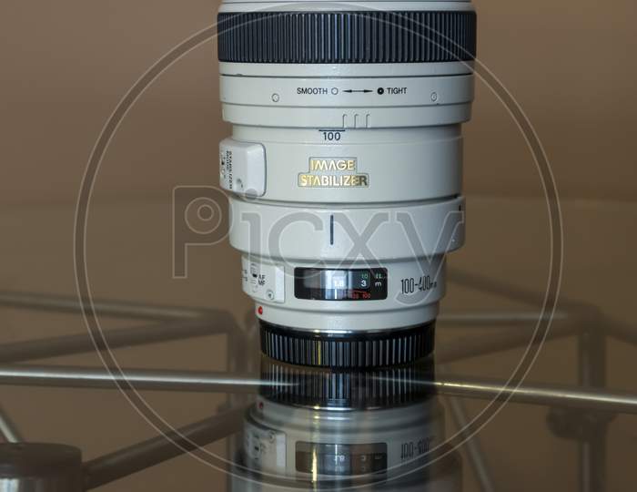 Cologne, Germany - September 28th 2020: A german photographer taking detailed pictures of his Canon EF 100-400 L 4.5-5.6 lens in order to sell it on eBay after changing his camera system.
