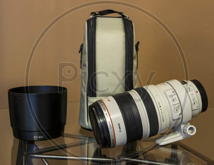 Cologne, Germany - September 28th 2020: A german photographer taking detailed pictures of his Canon EF 100-400 L 4.5-5.6 lens in order to sell it on eBay after changing his camera system.