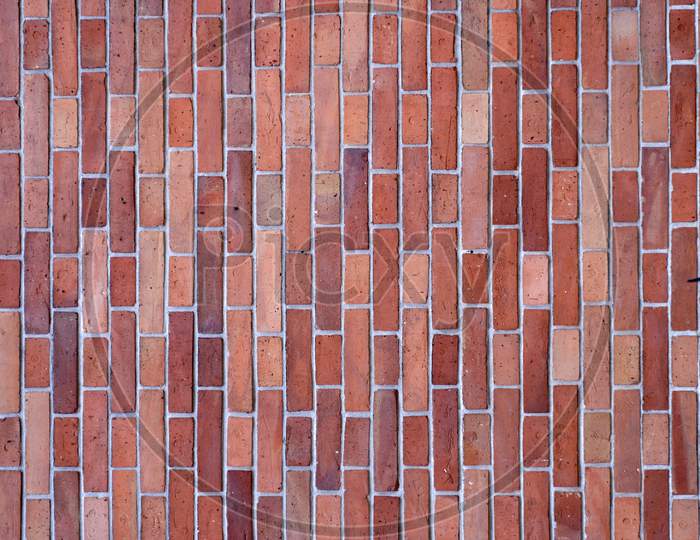 Wall Made Up Of Red Bricks Looking Stunning In Rectangular Pattern With Shadow Of Trident