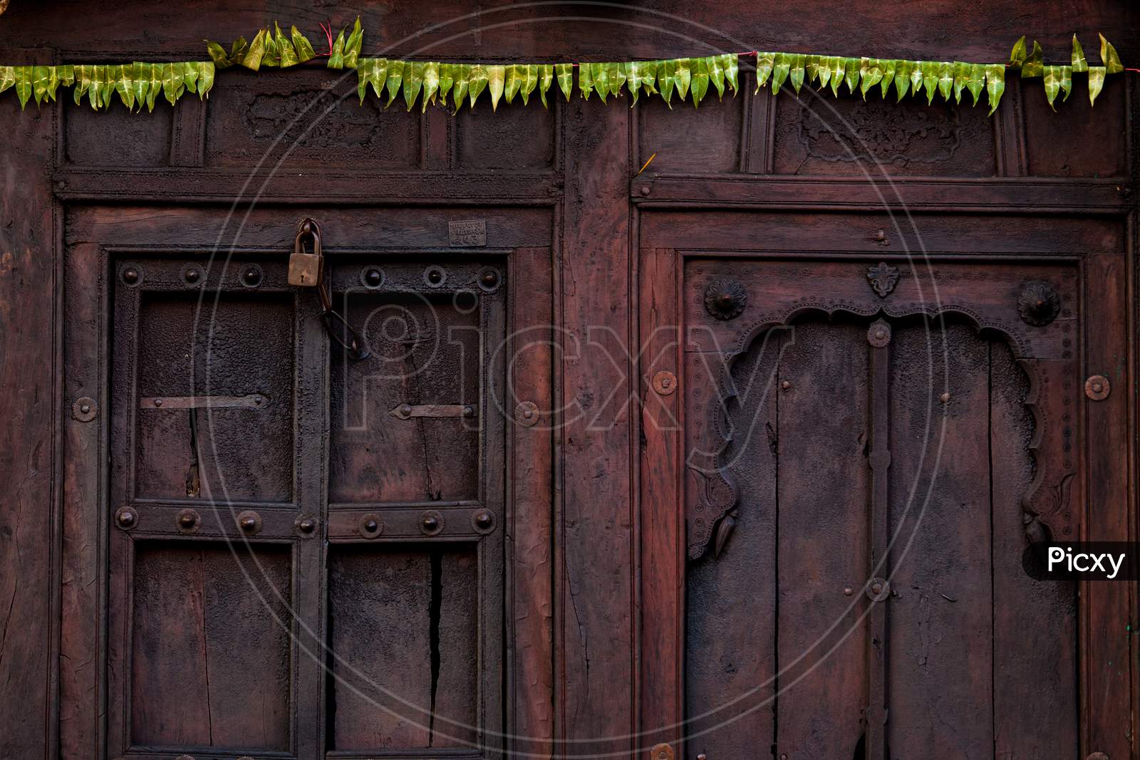 A Locked Wooden Door With Interesting Color & Pattern From A Village In India.