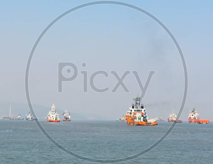 A Orange Rescue Boat Floating In The Vast Blue Water Near Mumbai