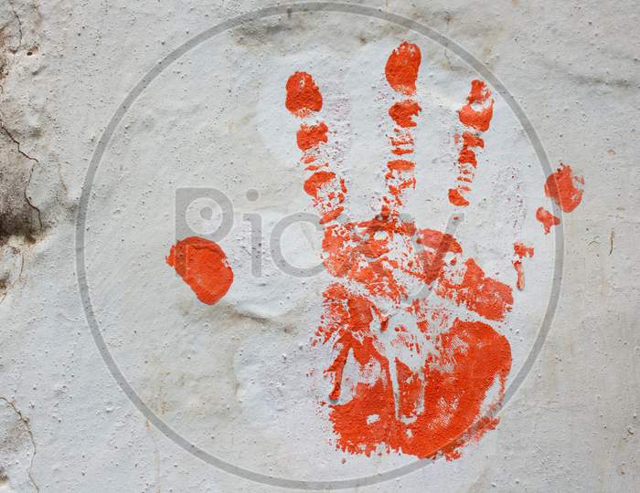 Red Hand Print On White Wall