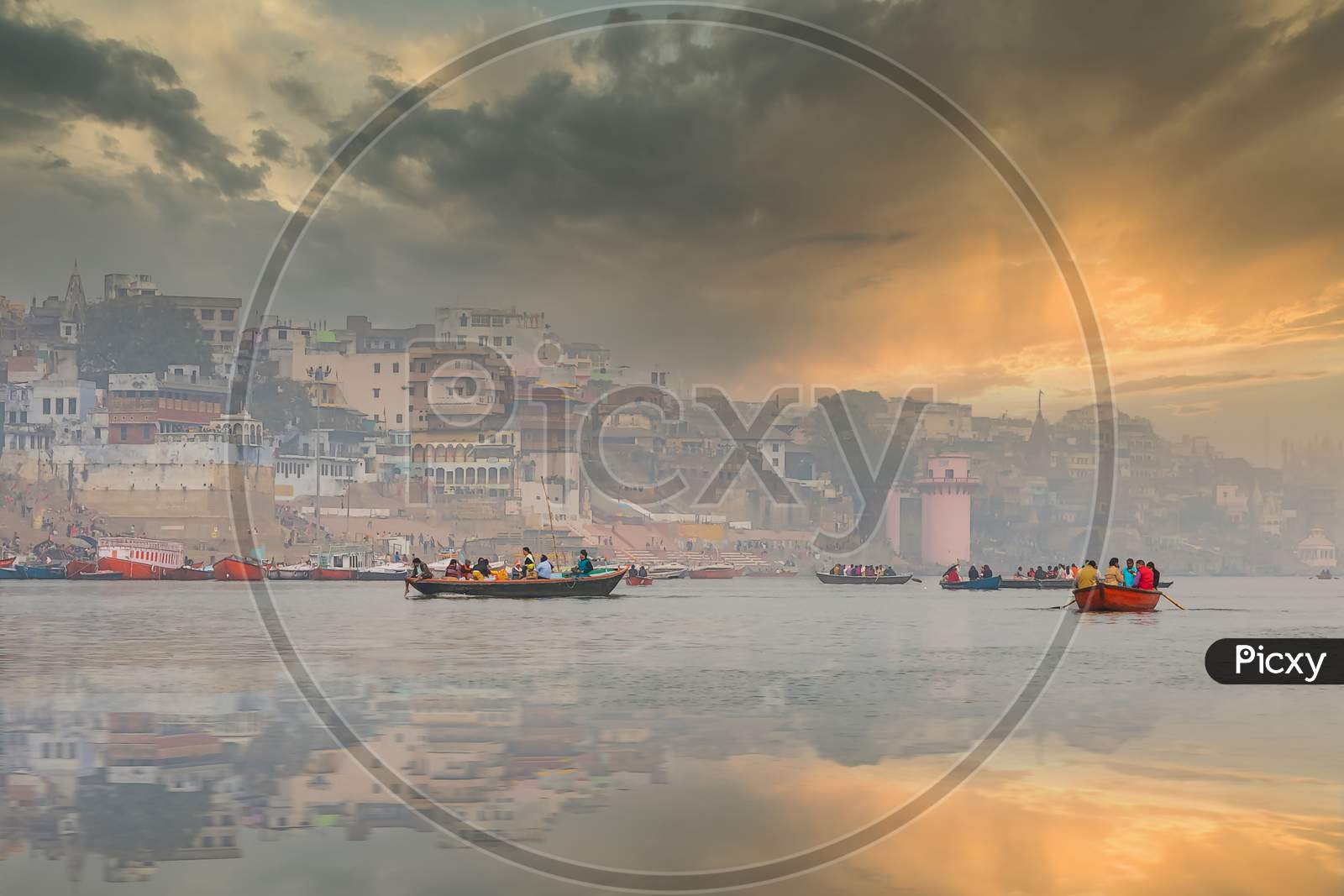 The refections of the historic homesteads of Varanasi India as seen from a boat on the river Ganges.