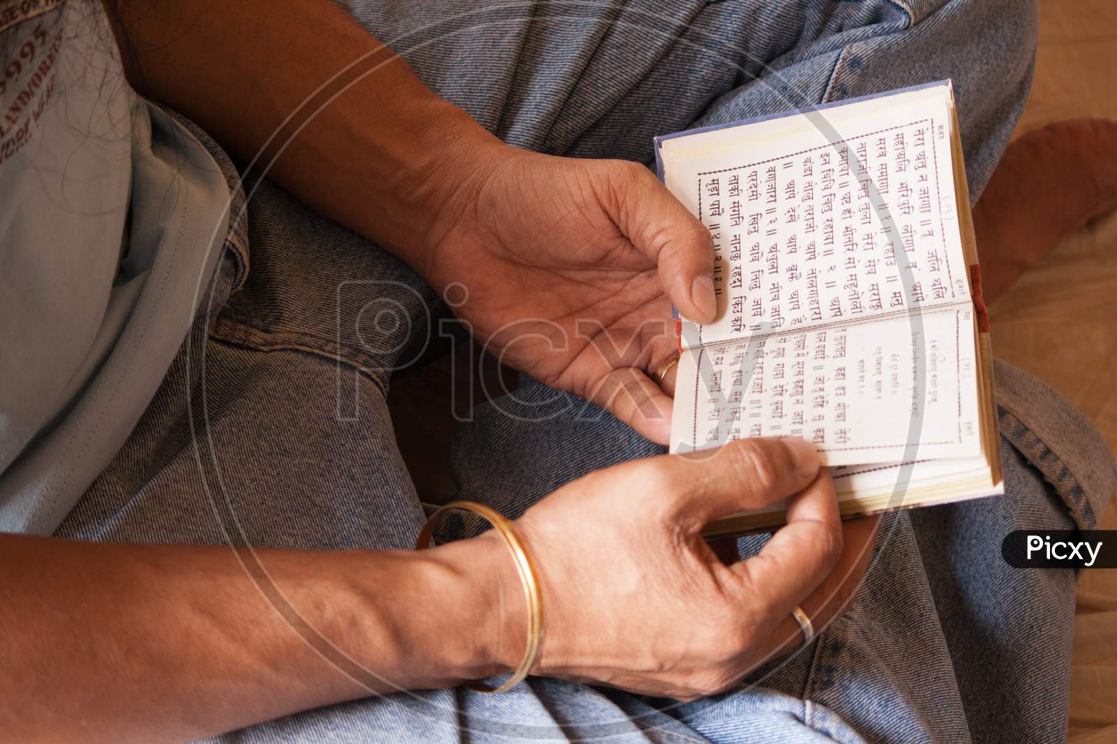 Closeup Of Sikh Person Reading Punjabi Holy Book