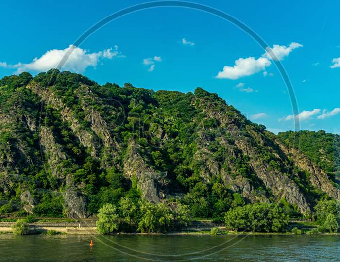 Germany, Hiking Frankfurt Outskirts, A Large Body Of Water With A Mountain In The Background