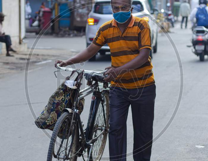 man on cycle wear mask