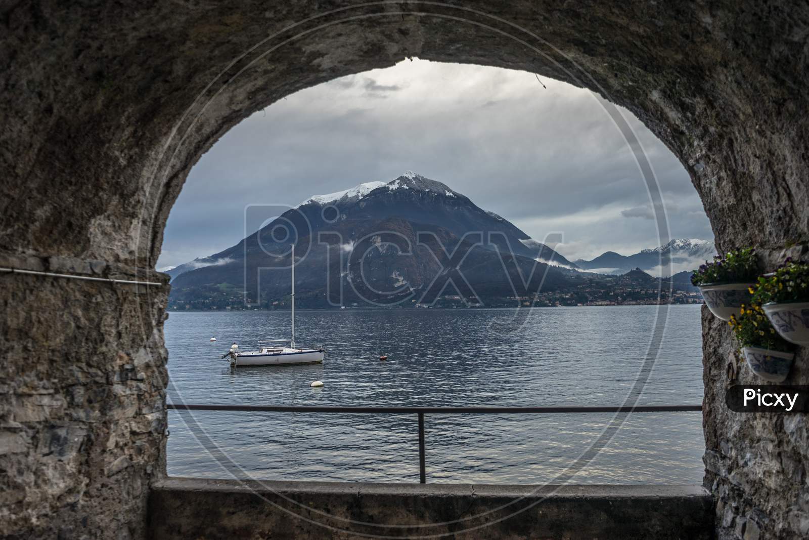 Italy, Varenna, Lake Como, Lonely Boat In A Lake Viewed Through Arch