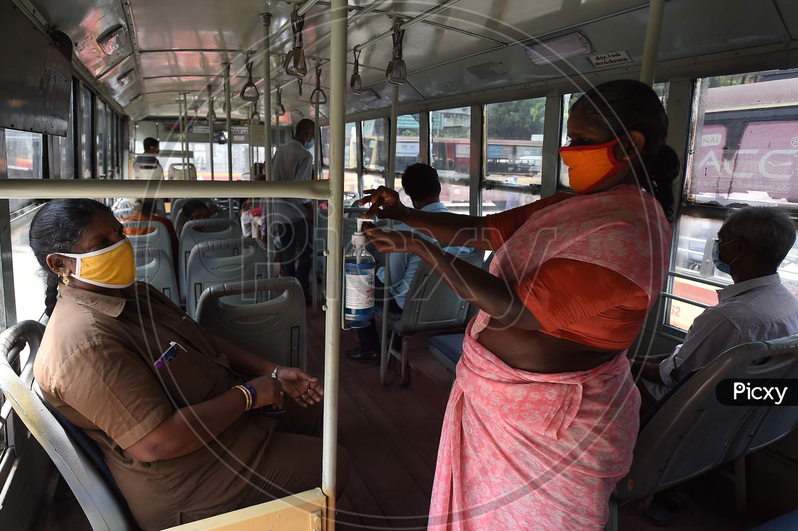 A Women Uses A Sanitiser As She Boards On A Public Bus After The Government Eased A Nationwide Lockdown Imposed As A Preventive Measure Against The Covid-19 Coronavirus, In Chennai On September 1, 2020.