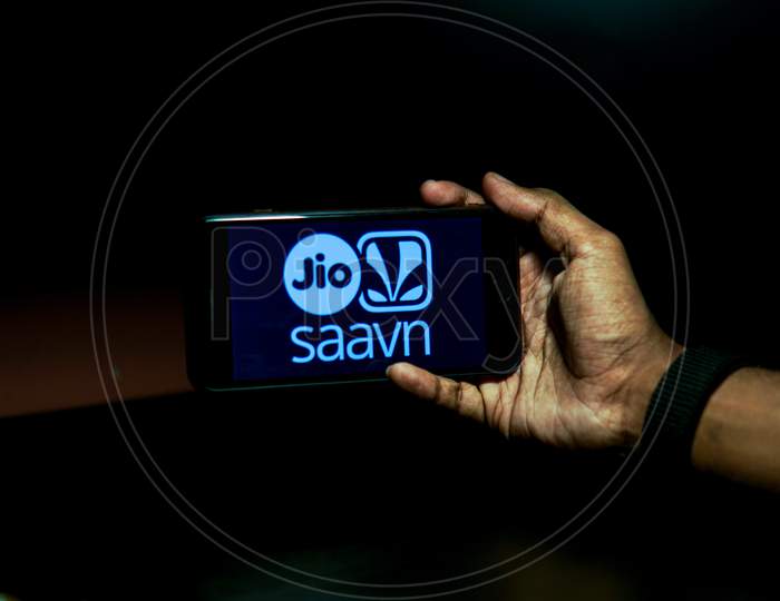 Jio Saavn Mobile App Icon Opening on Smartphone Screen Closeup