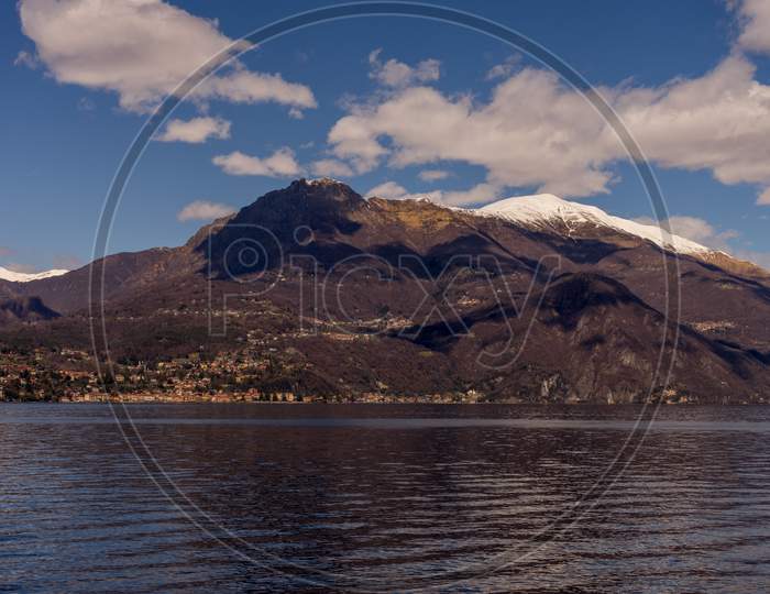 Italy, Bellagio, Lake Como, Scenic View Of Snowcapped Mountains Against Blue Sky, Lombardy
