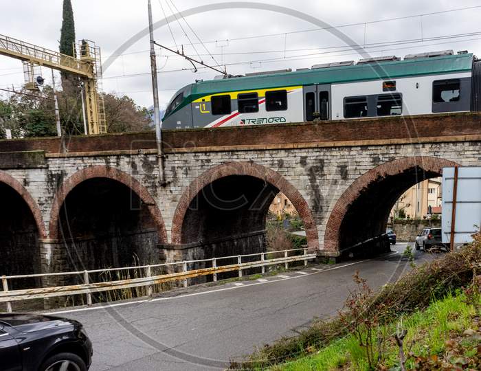 Varenna, Italy- March 31, 2018: Treinitalia Trenord Train At Varenna, Italy Travelling Over A Bridge