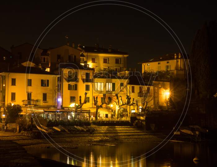 Italy, Varenna, Lake Como, A Lit Up City At Night