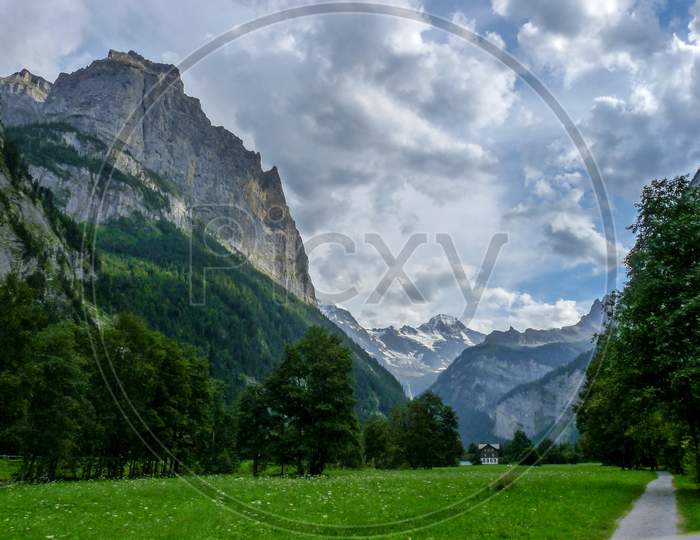 Switzerland, Lauterbrunnen, Scenic View Of Landscape And Mountains Against Sky