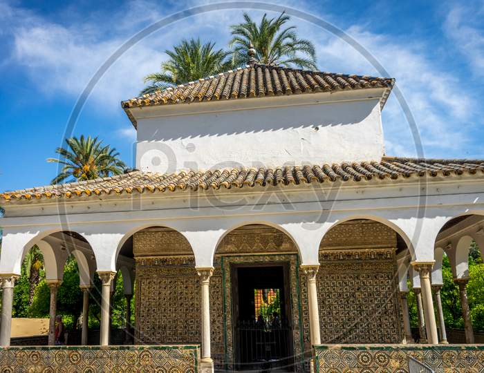 Seville, Spain - June 19: The Alcazar Garden With The Queen'S Room, Seville, Spain On June 19, 2017.