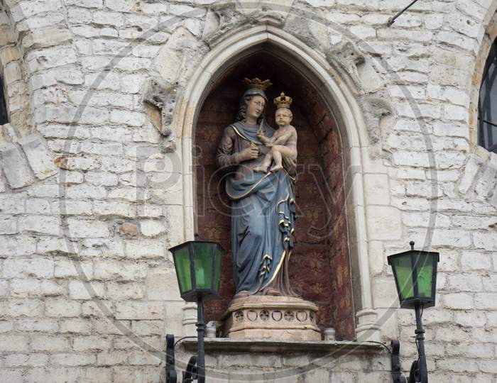Sculpture Of Mary Holding Baby Jesus On A Wall In The City Of Ghent, Belgium