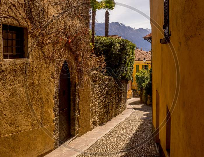 Italy, Menaggio, Lake Como, A View Of A Stone Cobblestone Street